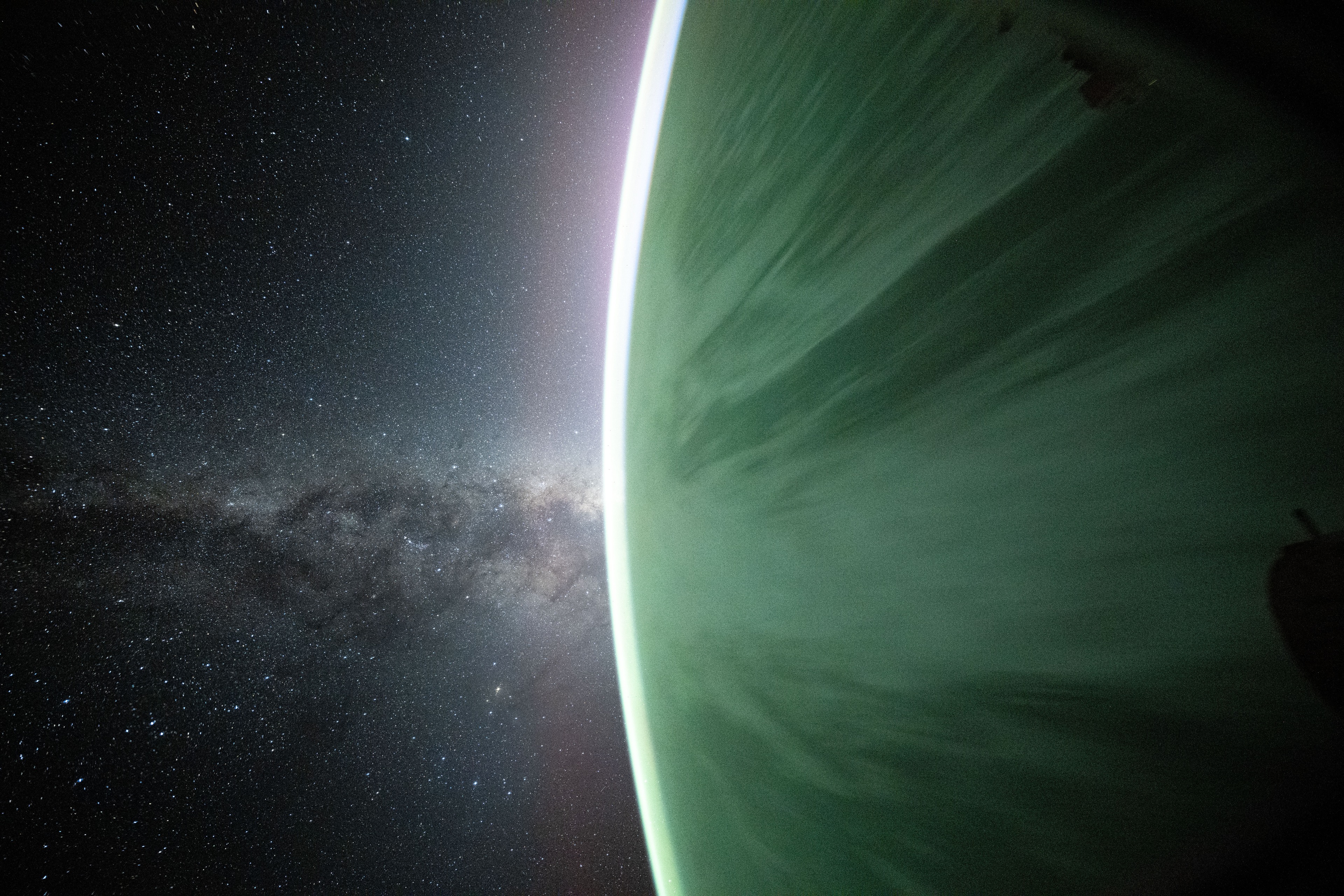 Earth and its luminous curved horizon beneath the Milky Way, photographed from the ISS by NASA astronaut Don Pettit